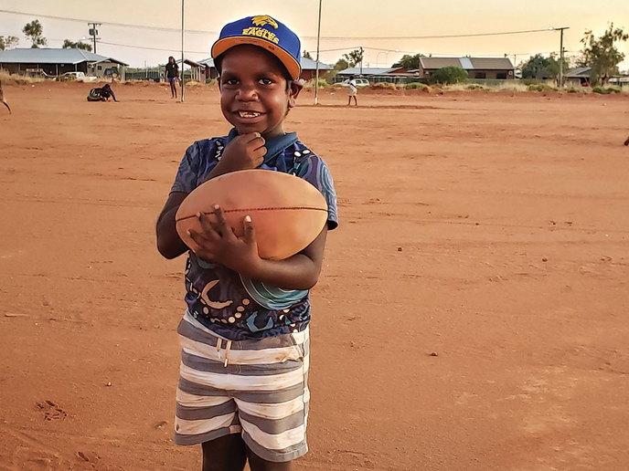 Fair Game program participant holding a football
